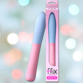 A sleek and elongated pink Bullet Vibrator from Femme Funn is showcased next to its packaging, which prominently displays an image of the product along with the label "Femme Funn FFIX Bullet XL Vibrator - Pink." The waterproof device offers 10 distinct vibration modes. The background features a blurred bokeh effect with soft, pastel-colored lights.